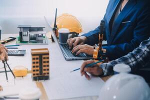 Image of engineer meeting for architectural project. working with partner and engineering tools on workplace vintage tone. photo