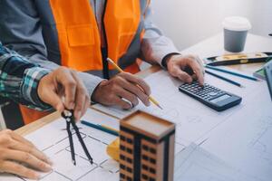 Image of engineer meeting for architectural project. working with partner and engineering tools on workplace vintage tone. photo