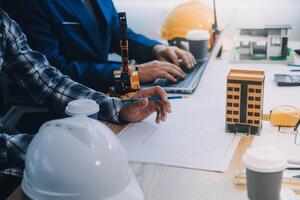 Image of engineer meeting for architectural project. working with partner and engineering tools on workplace vintage tone. photo