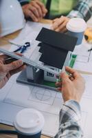 Image of engineer meeting for architectural project. working with partner and engineering tools on workplace vintage tone. photo