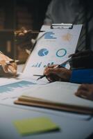 Business team meeting present, investor colleagues consultation and conference new strategy plan business and market growth on financial document graph report, Meeting and Talking. photo
