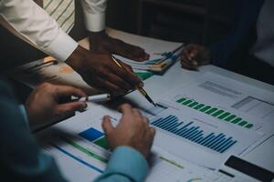 Business team meeting present, investor colleagues consultation and conference new strategy plan business and market growth on financial document graph report, Meeting and Talking. photo