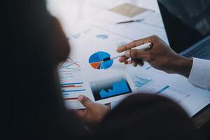 Business team collaboration discussing working analyzing with financial data and marketing growth report graph in team, presentation and brainstorming to strategy planning making profit of company. photo