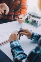 engineer people meeting working and pointing at a drawings in office for discussing. Engineering tools and construction concept. photo