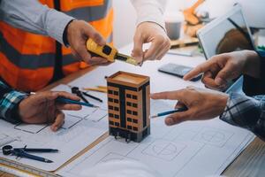 Image of engineer meeting for architectural project. working with partner and engineering tools on workplace vintage tone. photo