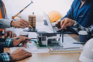 Image of engineer meeting for architectural project. working with partner and engineering tools on workplace vintage tone. photo