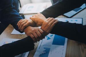 Business people join hands to join forces as a teamwork. photo