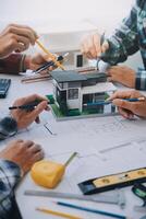 engineer people meeting working and pointing at a drawings in office for discussing. Engineering tools and construction concept. photo