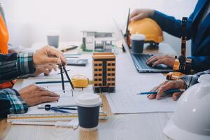 Image of engineer meeting for architectural project. working with partner and engineering tools on workplace vintage tone. photo