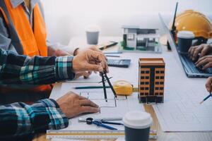 Image of engineer meeting for architectural project. working with partner and engineering tools on workplace vintage tone. photo