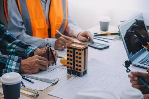 Image of engineer meeting for architectural project. working with partner and engineering tools on workplace vintage tone. photo