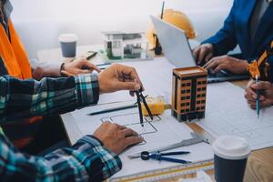 Image of engineer meeting for architectural project. working with partner and engineering tools on workplace vintage tone. photo