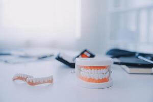 Denture and dental tools,dental mirror on white background photo