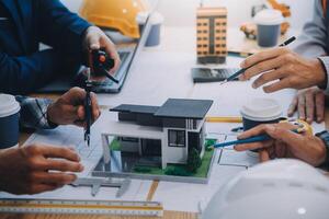 Image of engineer meeting for architectural project. working with partner and engineering tools on workplace vintage tone. photo