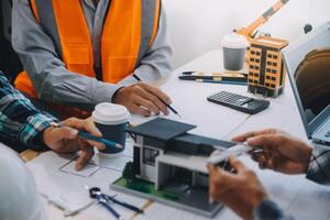 Image of engineer meeting for architectural project. working with partner and engineering tools on workplace vintage tone. photo