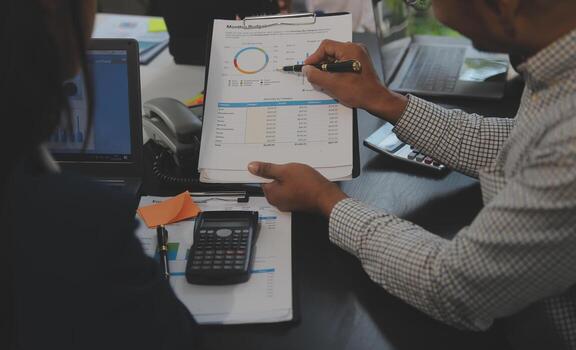 Business team meeting working with new startup project, discussion and analysis data the charts and graphs. Digital tablet, calculator, laptop computer using, Business finance and accounting concept. photo