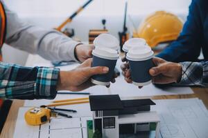 Image of engineer meeting for architectural project. working with partner and engineering tools on workplace vintage tone. photo