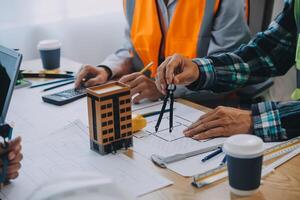 Image of engineer meeting for architectural project. working with partner and engineering tools on workplace vintage tone. photo