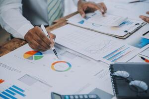 Business team collaboration discussing working analyzing with financial data and marketing growth report graph in team, presentation and brainstorming to strategy planning making profit of company. photo