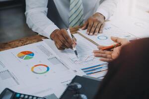 Business team collaboration discussing working analyzing with financial data and marketing growth report graph in team, presentation and brainstorming to strategy planning making profit of company. photo