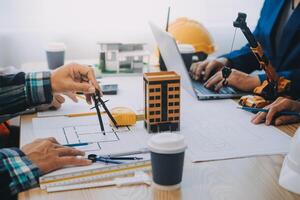 Image of engineer meeting for architectural project. working with partner and engineering tools on workplace vintage tone. photo