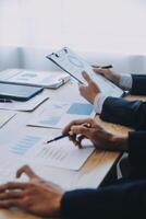 Meeting to present the Finance Executive business team. Discuss meetings to plan work, investment projects, analysis strategies, and discuss financial graphs and company budgets in the office. photo