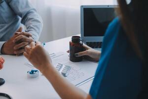 Doctor explaining brain functions to patient on model in office. photo