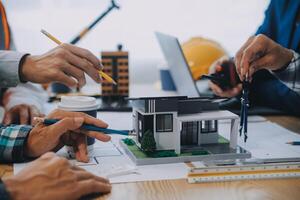 Image of engineer meeting for architectural project. working with partner and engineering tools on workplace vintage tone. photo