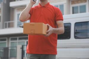 Asian delivery express courier young man use giving boxes to woman customer he wearing protective face mask at front home photo