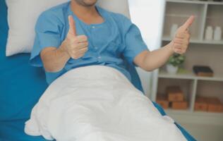 Portrait of happy caucasian sick patient on bed in hospital in medical and healthcare treatment at nursing home or clinic. People lifestyle photo