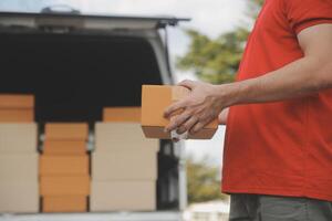 Asian delivery express courier young man use giving boxes to woman customer he wearing protective face mask at front home photo