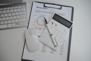 Laptop and paperwork on conference table photo