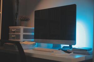 Laptop and paperwork on conference table photo