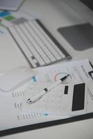 Laptop and paperwork on conference table photo