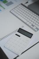 Laptop and paperwork on conference table photo