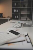 Laptop and paperwork on conference table photo