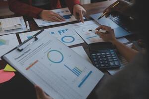 Finance manager meeting discussing company growth project success financial statistics, professional investor working start up project for strategy plan with document, laptop and digital tablet. photo