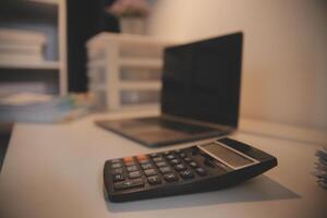 Laptop and paperwork on conference table photo