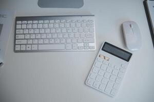 Laptop and paperwork on conference table photo