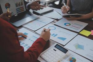 Finance manager meeting discussing company growth project success financial statistics, professional investor working start up project for strategy plan with document, laptop and digital tablet. photo