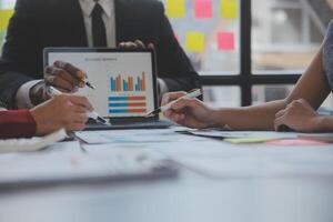 Finance manager meeting discussing company growth project success financial statistics, professional investor working start up project for strategy plan with document, laptop and digital tablet. photo