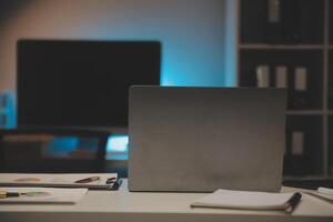 Laptop and paperwork on conference table photo