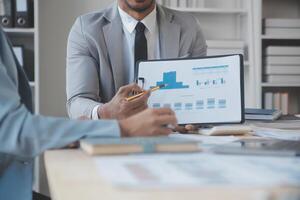 Finance manager meeting discussing company growth project success financial statistics, professional investor working start up project for strategy plan with document, laptop and digital tablet. photo