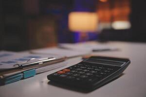 Business woman using calculator for do math finance on wooden desk in office and business working background, tax, accounting, statistics and analytic research concept photo