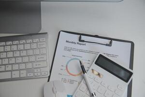 Laptop and paperwork on conference table photo