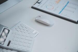 Laptop and paperwork on conference table photo