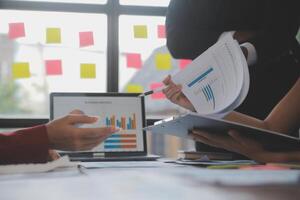 Finance manager meeting discussing company growth project success financial statistics, professional investor working start up project for strategy plan with document, laptop and digital tablet. photo