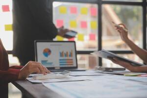 Finance manager meeting discussing company growth project success financial statistics, professional investor working start up project for strategy plan with document, laptop and digital tablet. photo