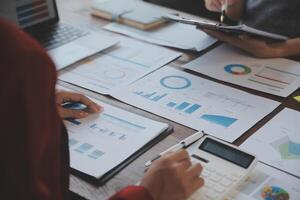 Finance manager meeting discussing company growth project success financial statistics, professional investor working start up project for strategy plan with document, laptop and digital tablet. photo