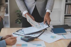 Finance manager meeting discussing company growth project success financial statistics, professional investor working start up project for strategy plan with document, laptop and digital tablet. photo